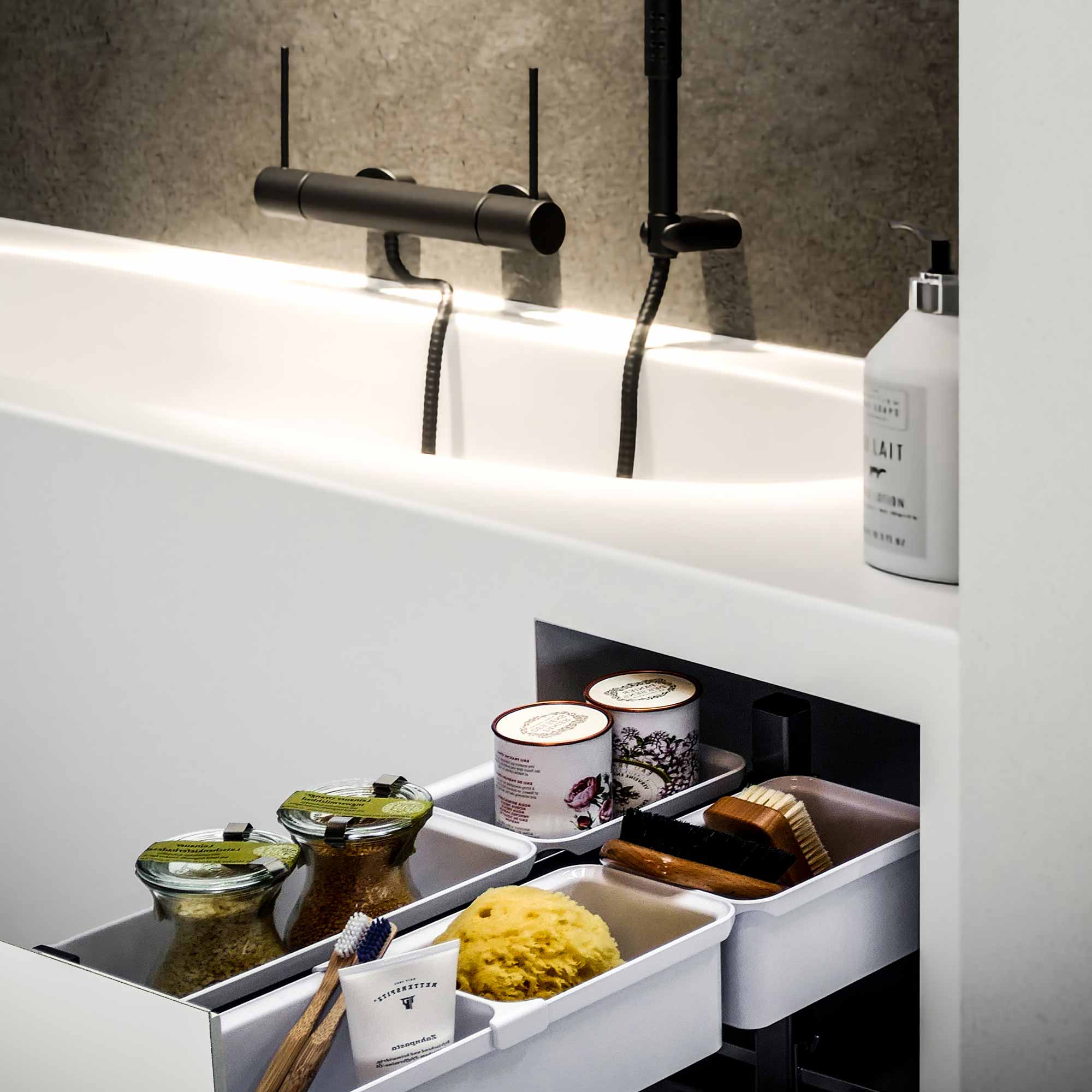 Ausgefahrener Auszug, der in eine weiße Badewanne integriert ist.