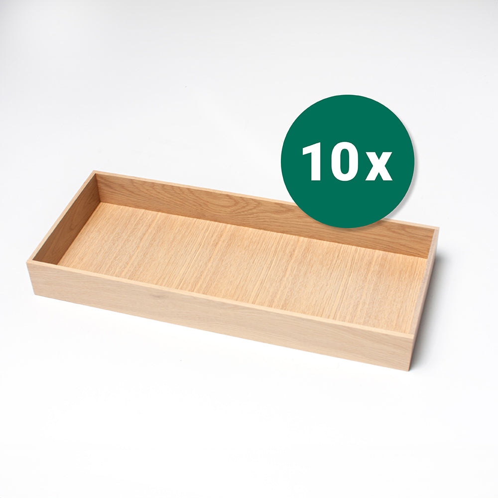 Der MOVE Organisationseinsatz Eiche Weiß gebeizt (200x479x55 mm) ist ein rechteckiges Holztablett mit einer hellen Holzmaserung auf weißem Hintergrund. Als 10-teiliges Set verkauft, ist es perfekt für die Organisation von Schubladen oder als Einsatz zu verwenden.